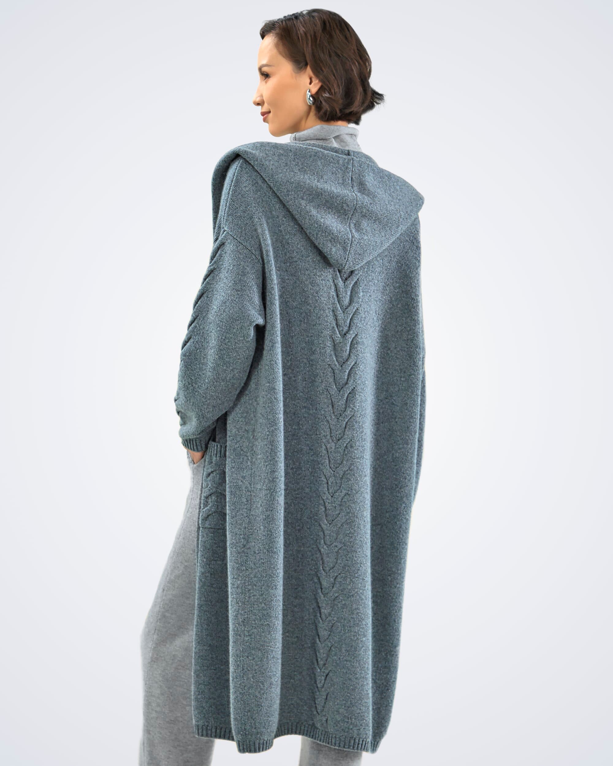 Model wearing a dark grey cable knit cashmere long cardigan with hoodie, rear view