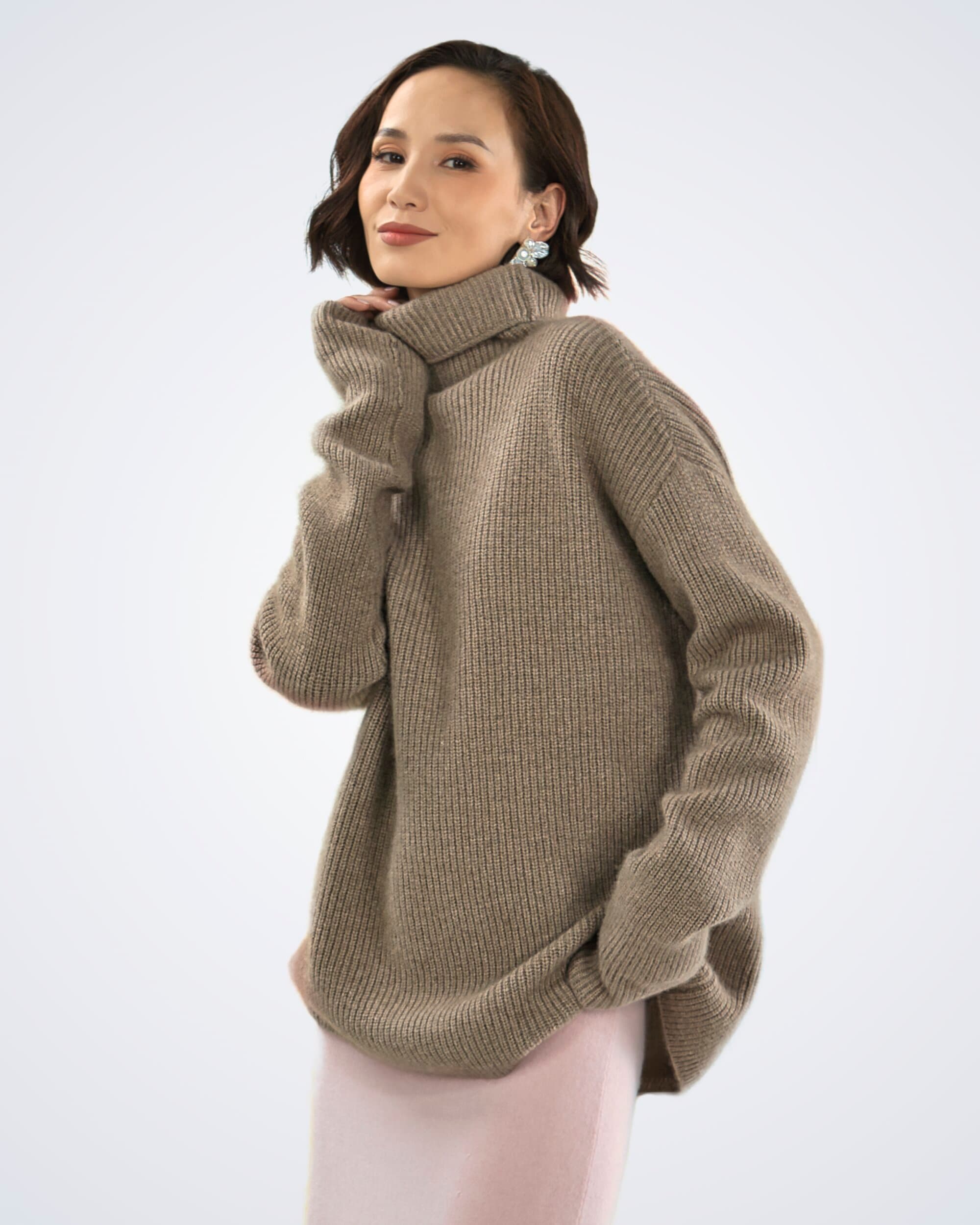 model wearing an oversized roll neck ribbed cashmere jumper in natural brown